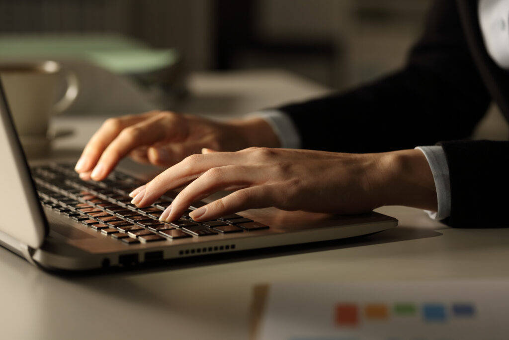 About business woman hands typing on laptop at night